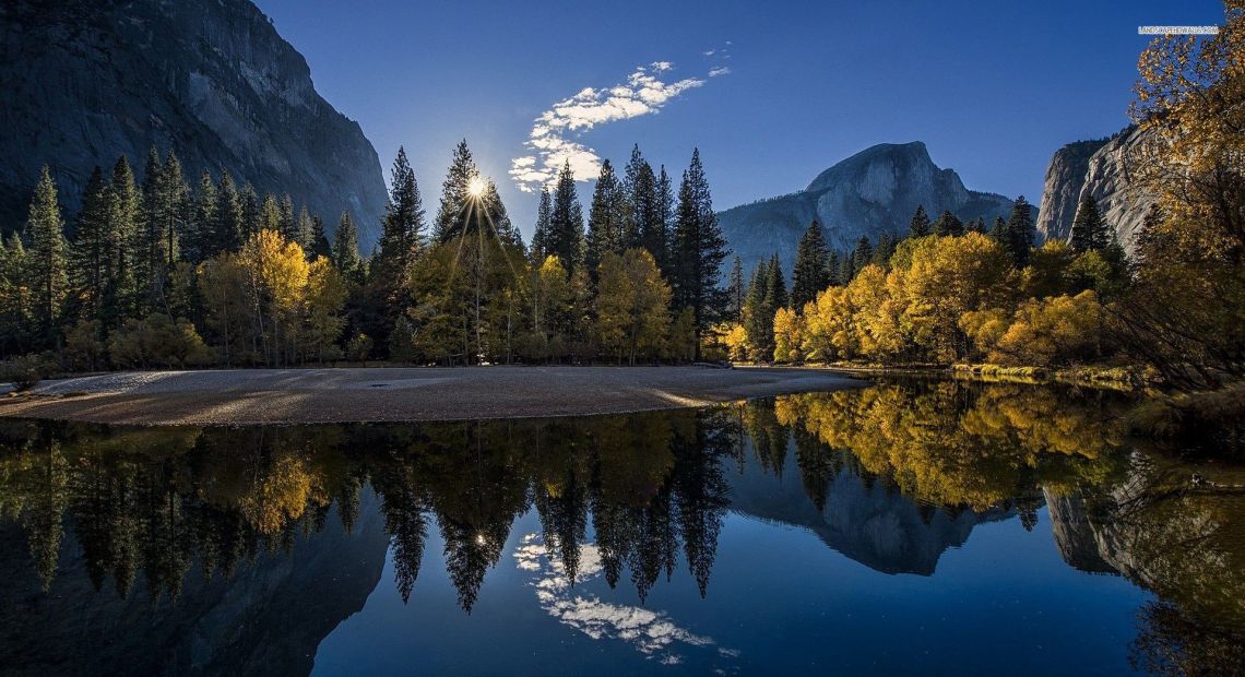 crystal lake in mountains surrounded by forest