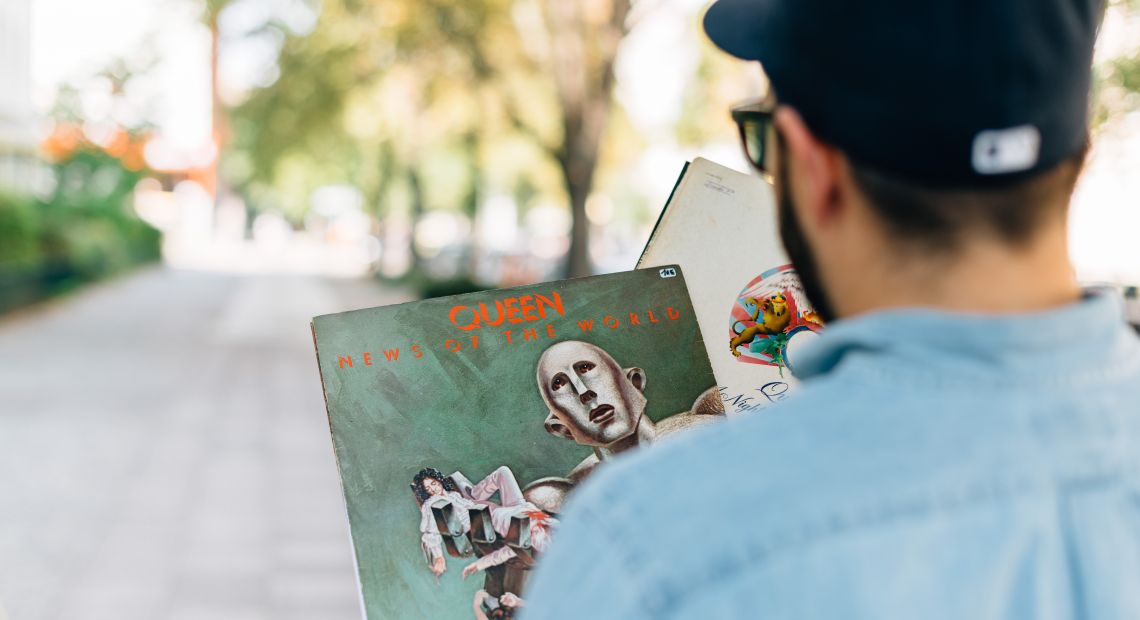 Man holding a Queen vintage vinyl