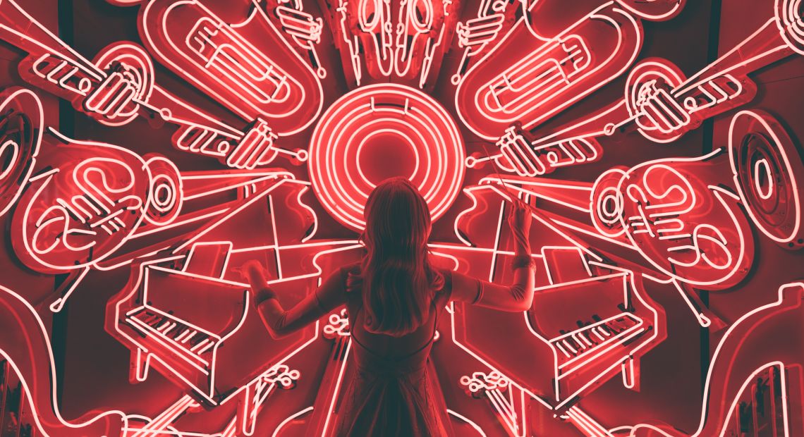 Woman standing watching LED light musical instrument