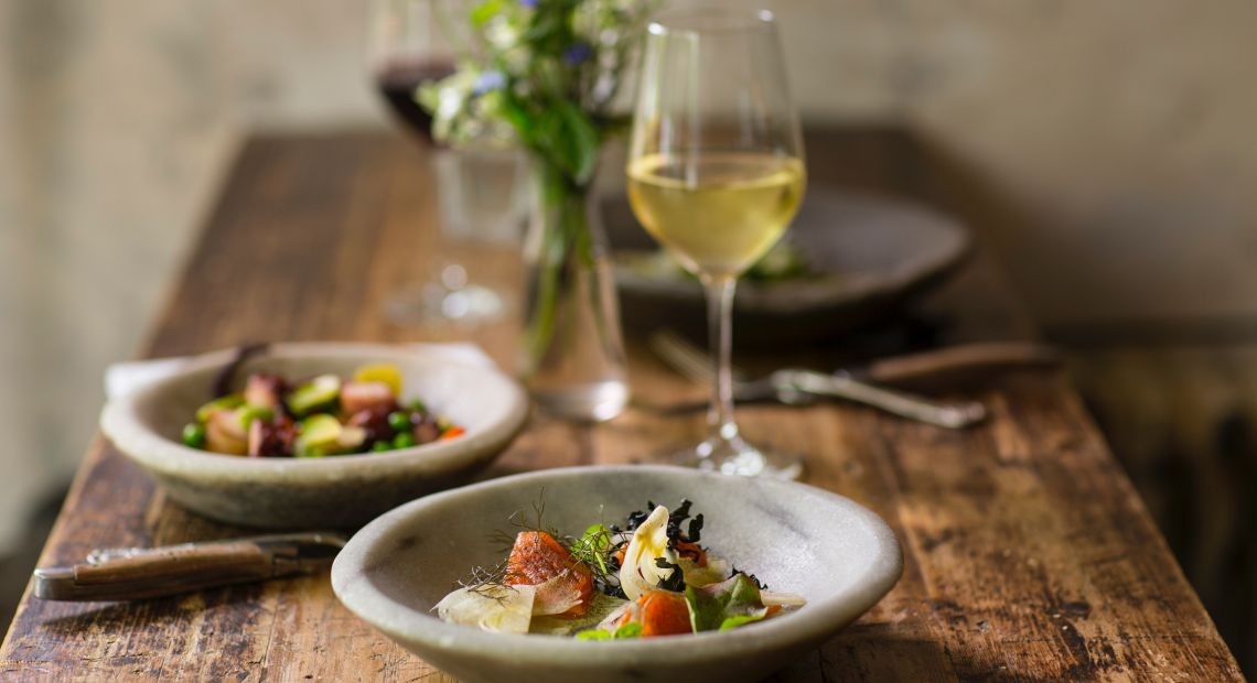 Delicious food on a stylish plate and white wine