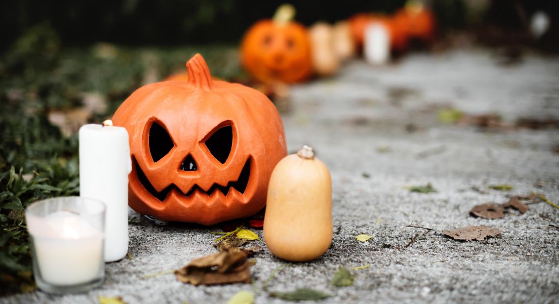 Jack-o-lantern and candles on the ground