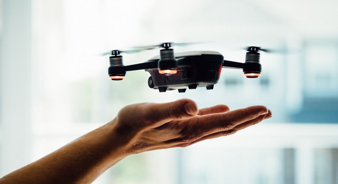 Human holding a drone