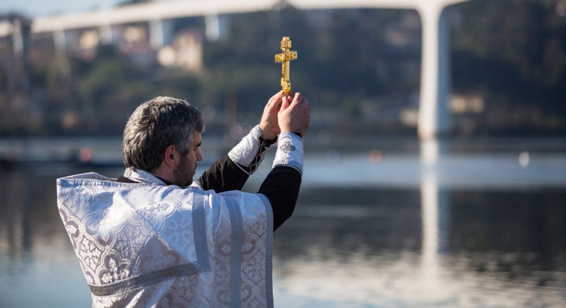 Priest blessing the water