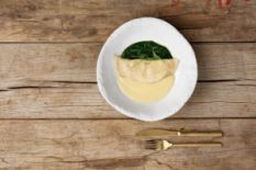 dumpling with sauce served on wooden table