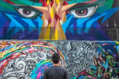 Man looking at bright street art