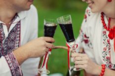 Couple sharing a glass of nalyvka on a picnic