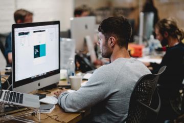 Man working at the Apple computer