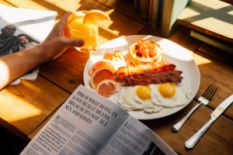 Person having eggs and juice for breakfast
