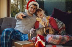 Couple watching TV with a dog