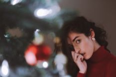 Girl standing by the Christmas tree