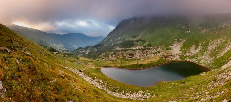oval lake in mountains