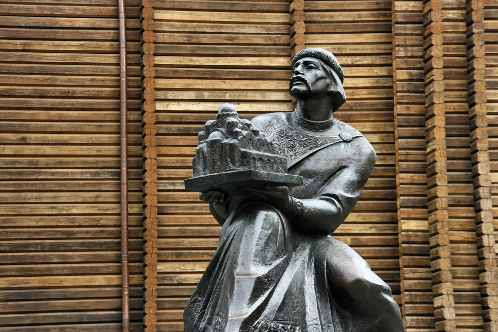 stone monument to Yaroslaw the Wise near wooden wall