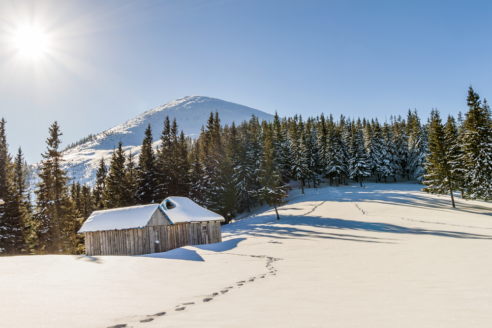 small wooden house in winter mountains