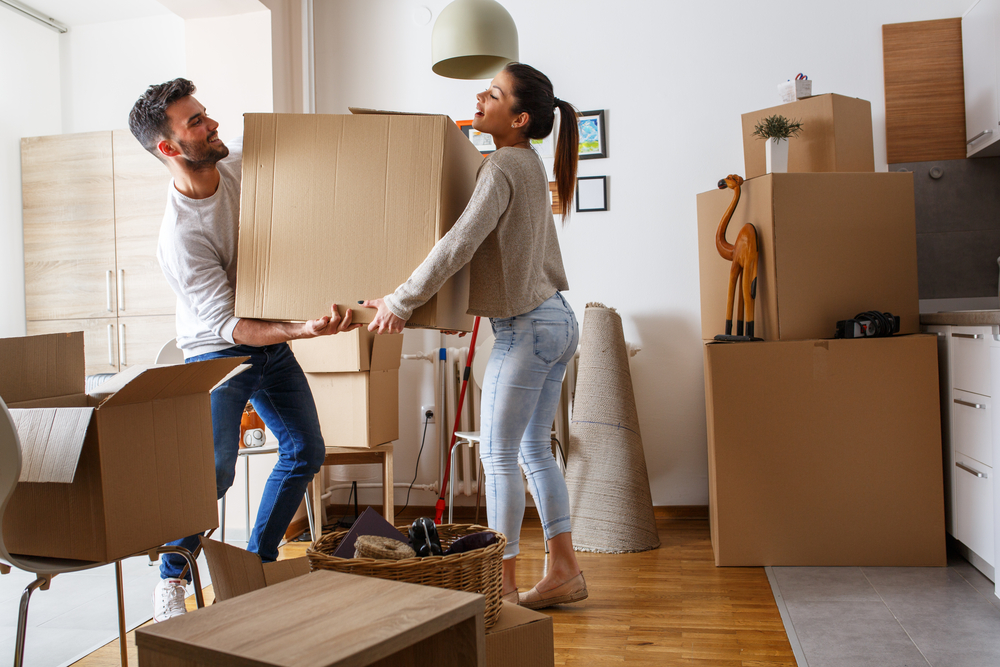 couple bringing heavy box
