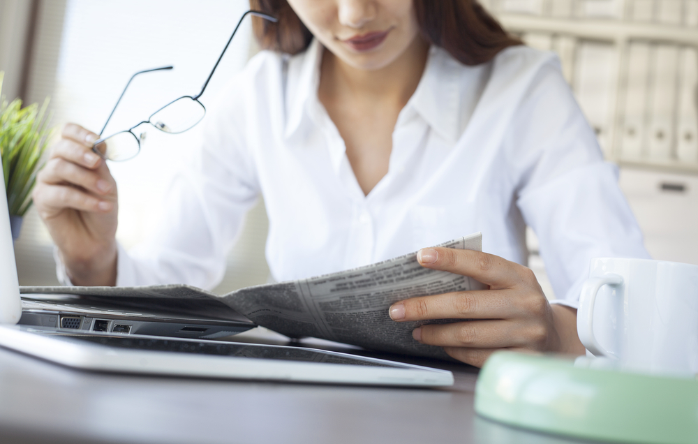 lady is reading newspaper