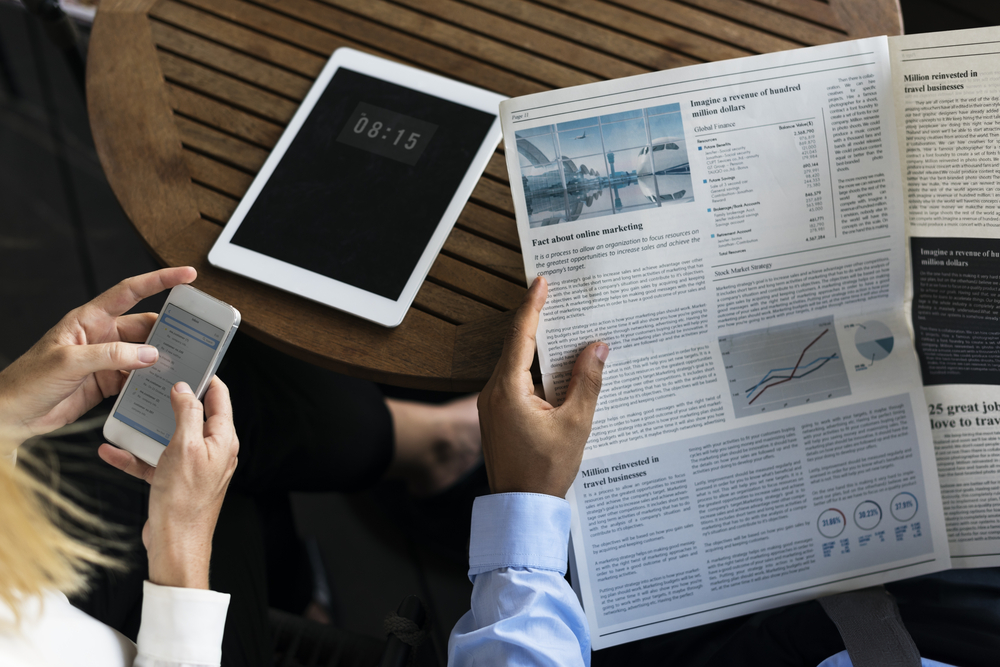 newspaper, smartphone and tablet