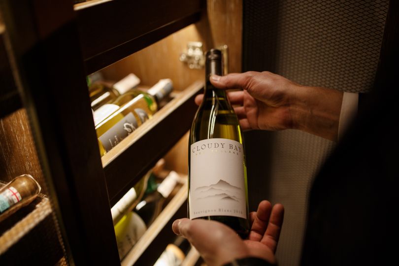 Person holding a bottle of wine