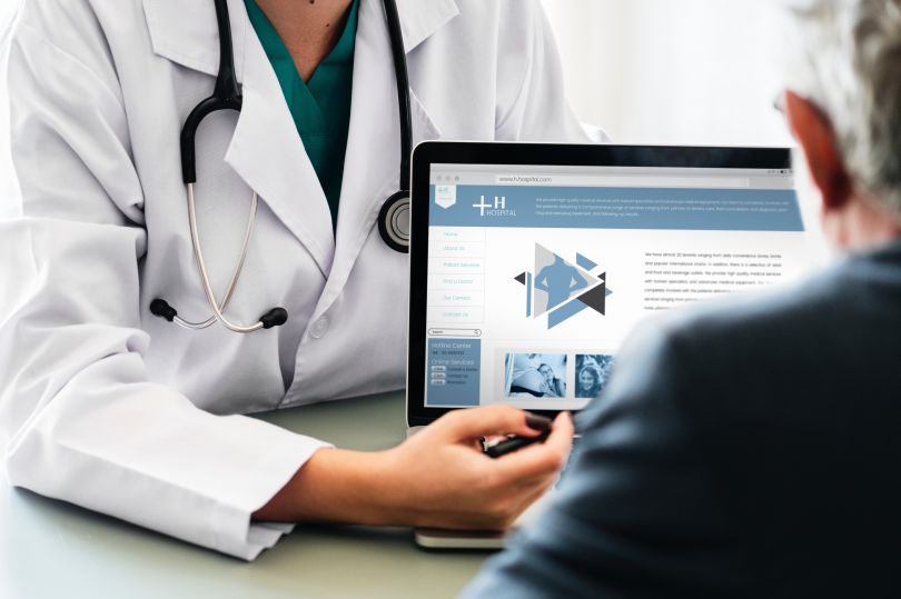 doctor showing patient website ob computer