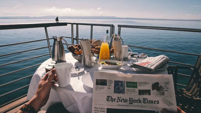 Chilling near the sea with a newspaper