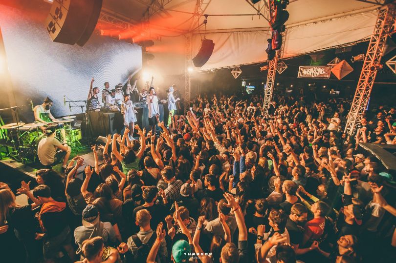 crowd dancing at rave event