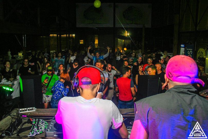 two djs playing in club