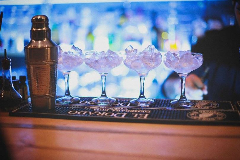 cocktails with ice in glasses on bar counter