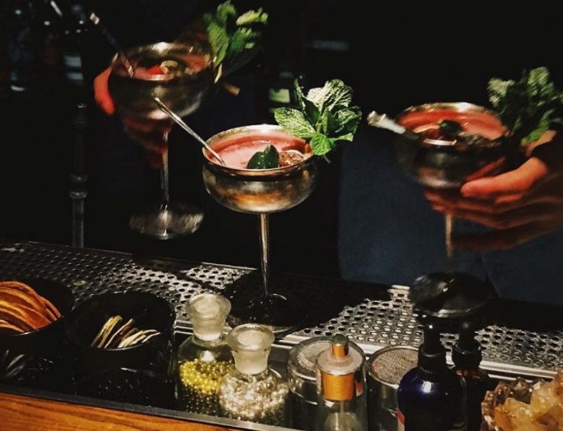 three fancy cocktails in glasses