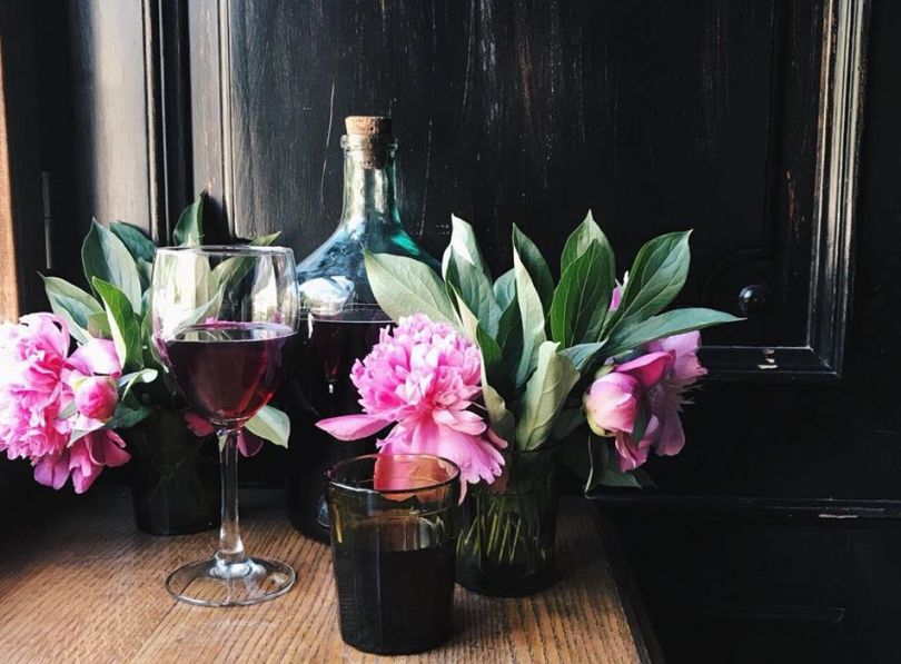 wine bottle, glass and flowers