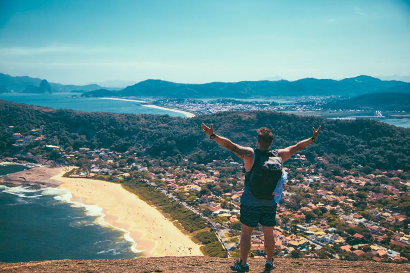 man on mountain over city