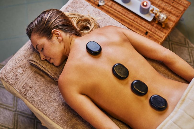 woman receiving a stone massage