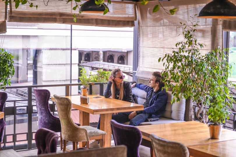 couple on restaurant`s warm terrace