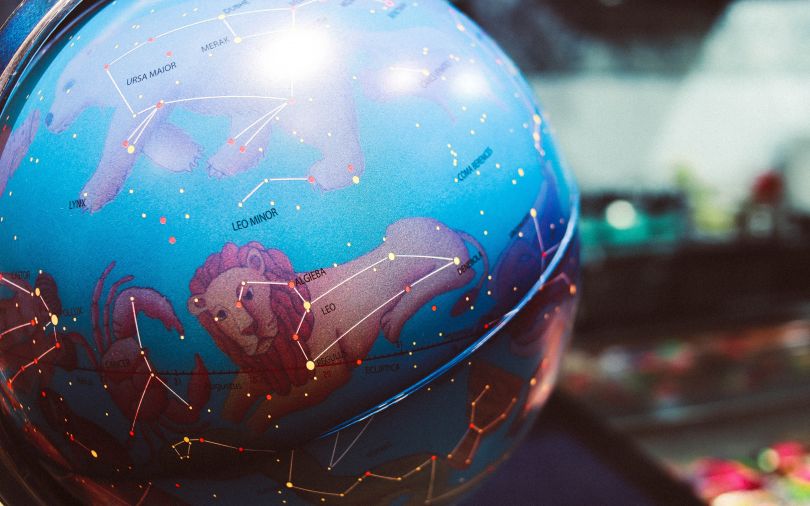 globe with zodiac signs
