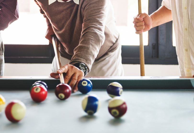 male hands playing billiards