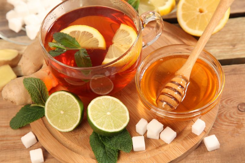 tea with oranges and pot with honey