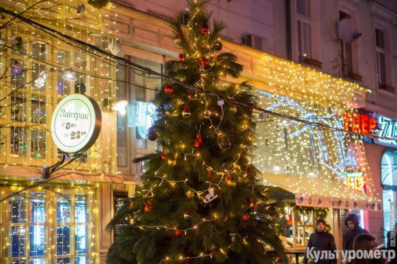Christmas tree near building with clock