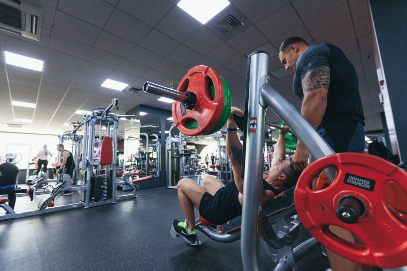 Guy working out with weights
