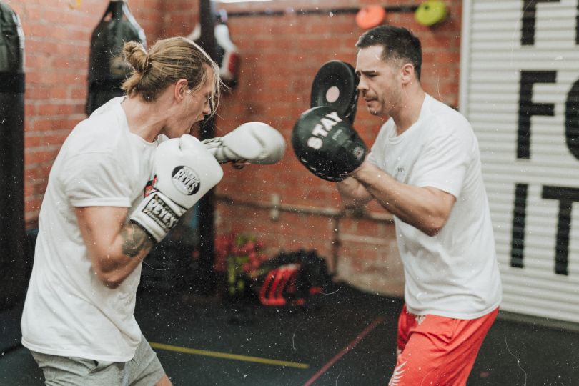 Dudes boxing in a gym