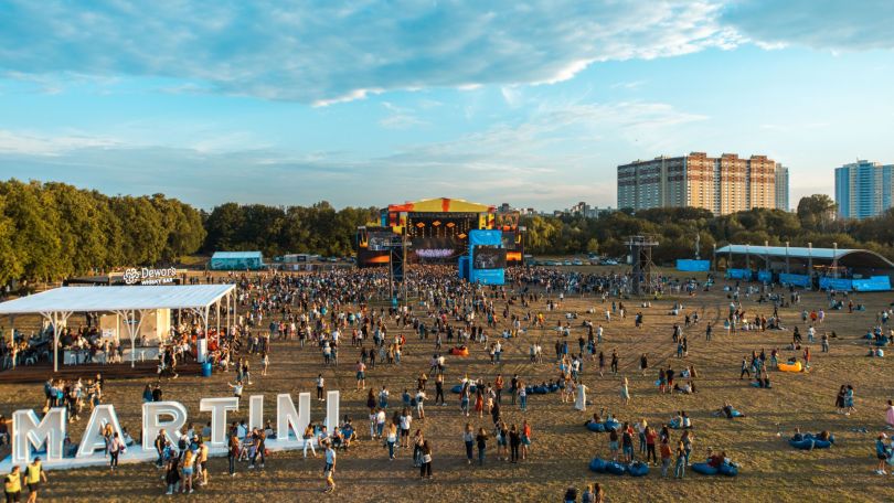 crowd near festival stage and bar