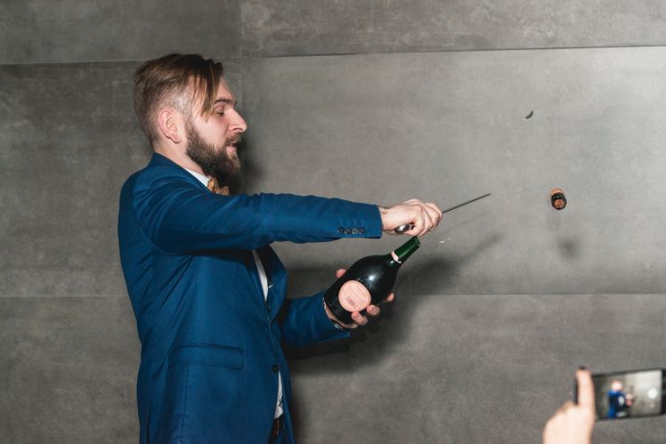 Bohdan opening wine bottles at work 