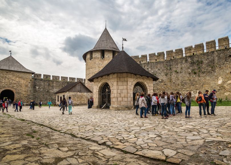 people in the yard of old stone fortress