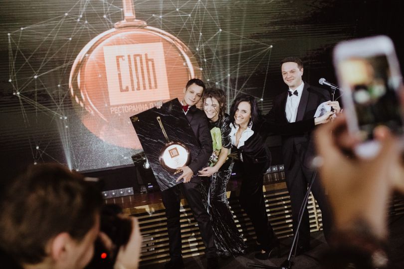 people on stage receiving award