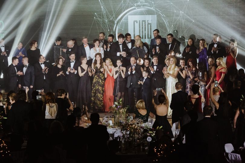 many people on stage attending award ceremony