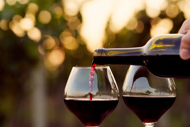 Man pouring red wine