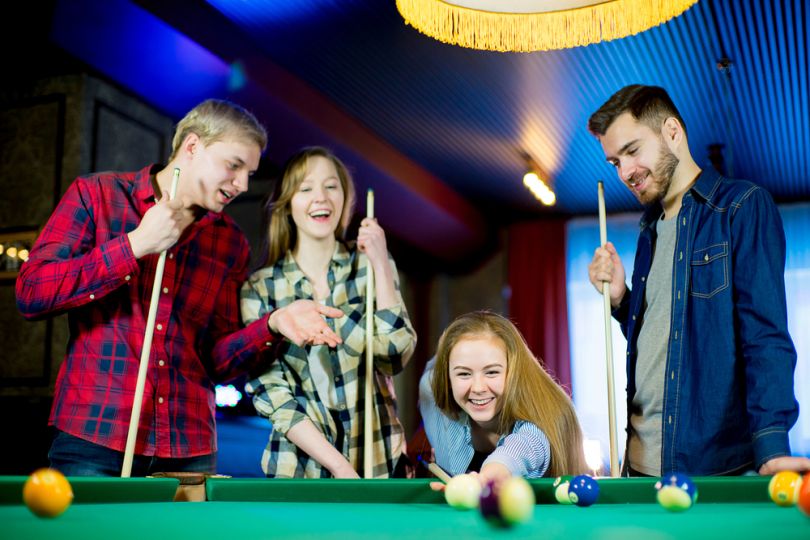 Company enjoying billiards